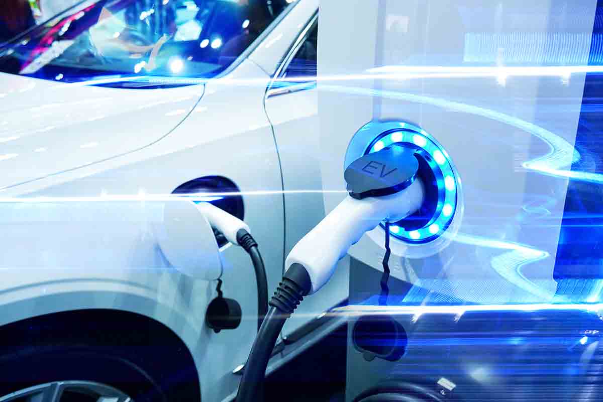 Commercial EV Charging Point Installation | Ranet Cables Inc electric car plugged in to ev charging point station in car park
